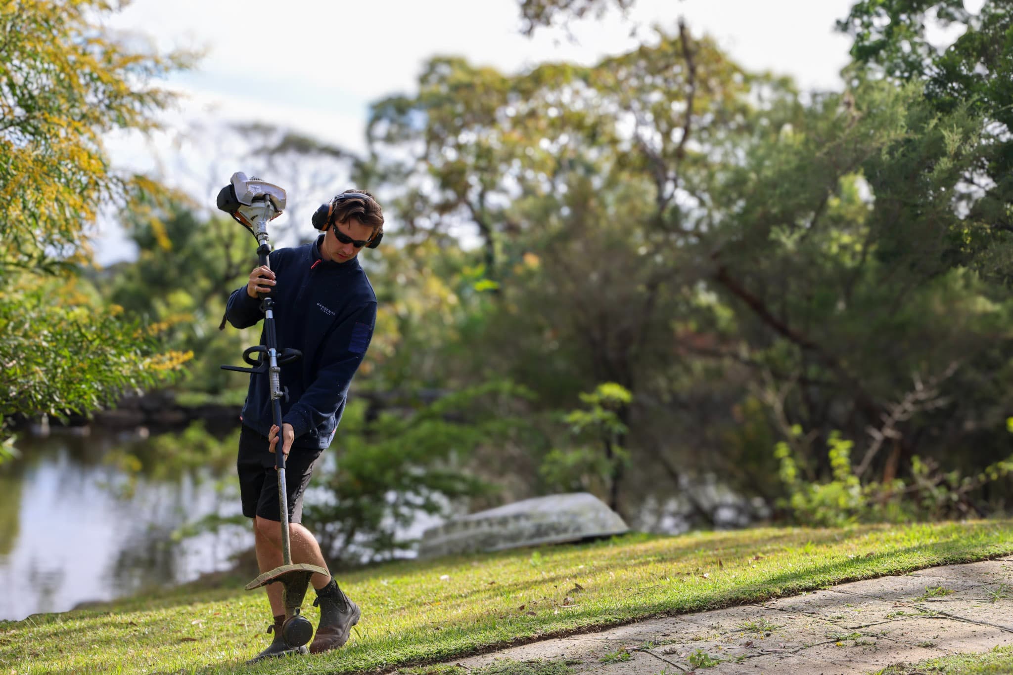 Gardening Sydney crew member edging a lawn