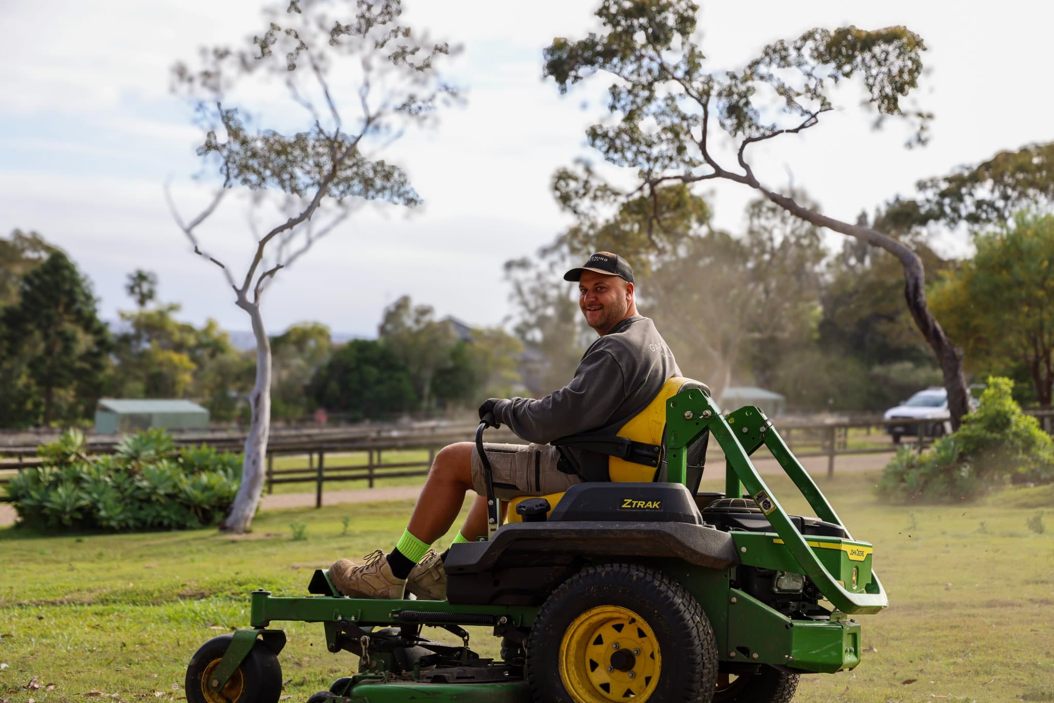 Gardening Sydney crew member on a ride-on mower